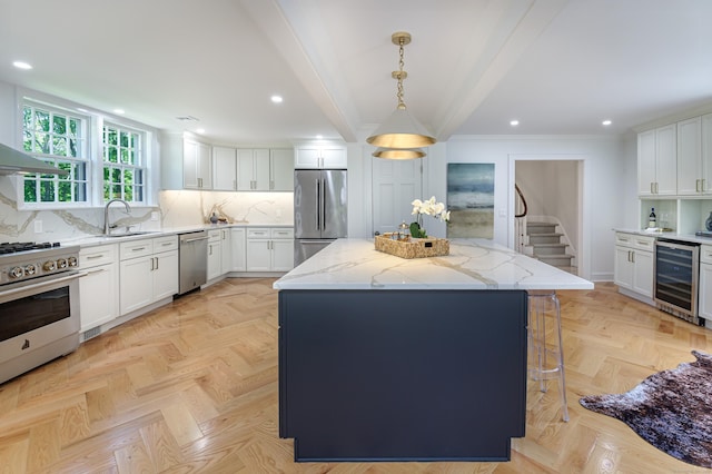 182 Bennetts Farm Rd, Ridgefield, CT 06877 - kitchen with stainless steel appliances, beverage cooler, a center island, light stone countertops, and white cabinets