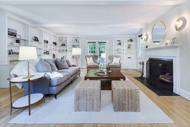 182 Bennetts Farm Rd, Ridgefield, CT 06877 - living room with wood finished floors, a fireplace with flush hearth, beamed ceiling, and built in shelves