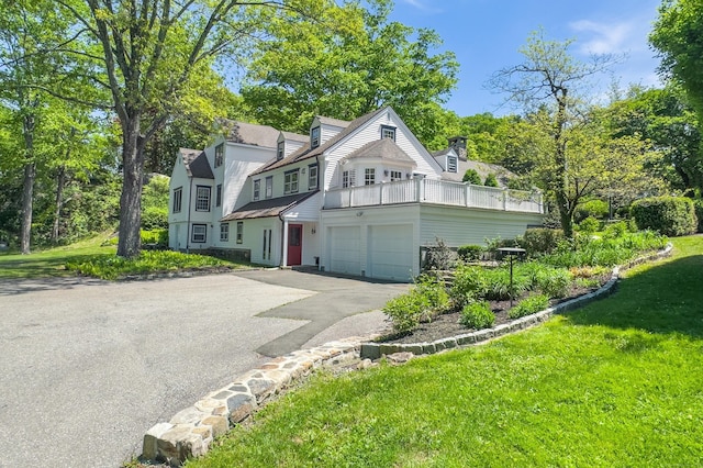 182 Bennetts Farm Rd, Ridgefield, CT 06877 - view of front of house featuring driveway, a front yard, an attached garage, and a balcony