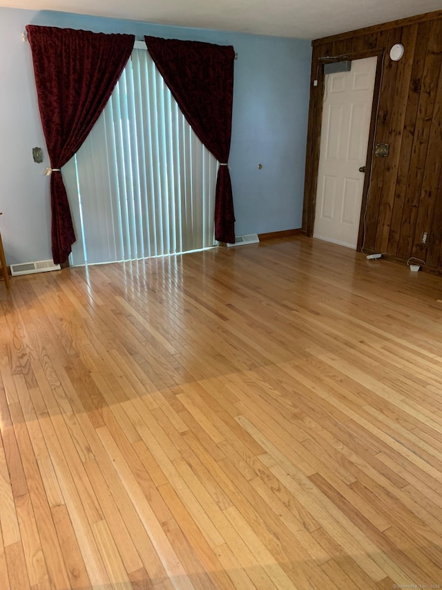 180 Round Hill Rd, Cheshire, CT 06410 - empty room featuring light wood-style flooring and wood walls