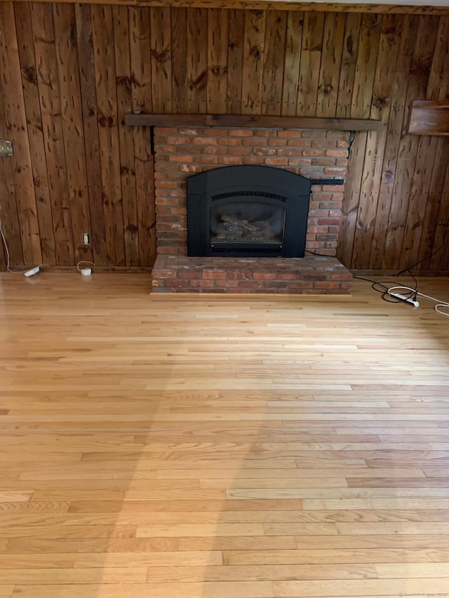 180 Round Hill Rd, Cheshire, CT 06410 - detailed view of wood finished floors, a brick fireplace, and wooden walls