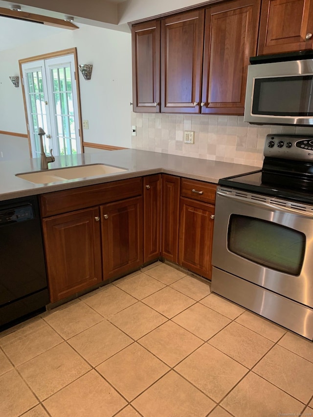 180 Round Hill Rd, Cheshire, CT 06410 - kitchen with stainless steel appliances, tasteful backsplash, and light tile patterned floors