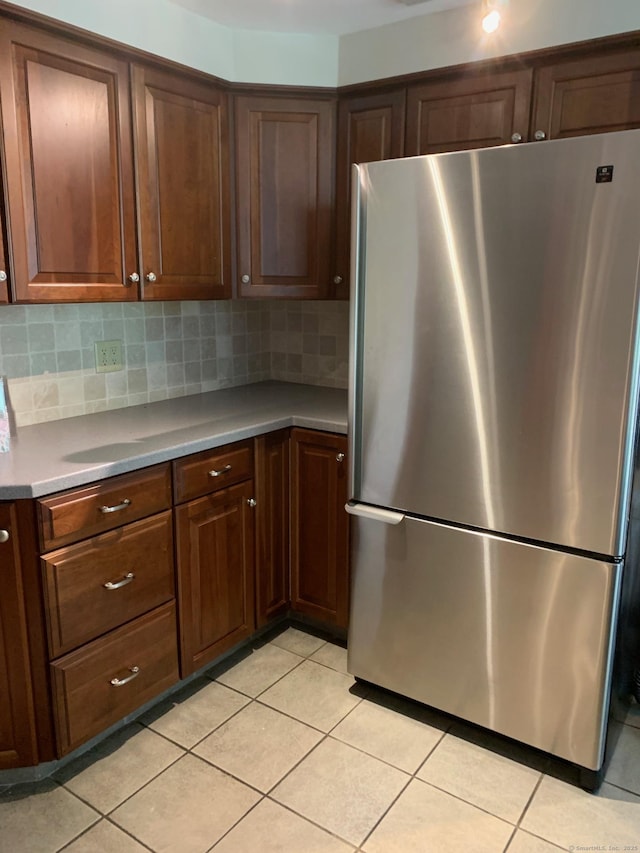180 Round Hill Rd, Cheshire, CT 06410 - kitchen featuring freestanding refrigerator, light tile patterned floors, backsplash, and light countertops