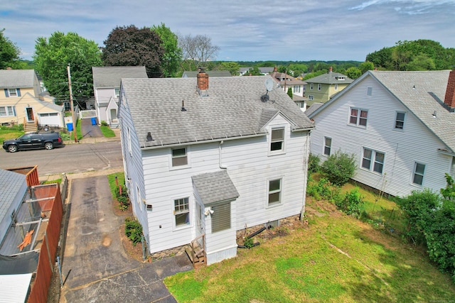 42 Marlboro St, Waterbury, CT 06705 - back of property featuring a shingled roof, a chimney, and a residential view
