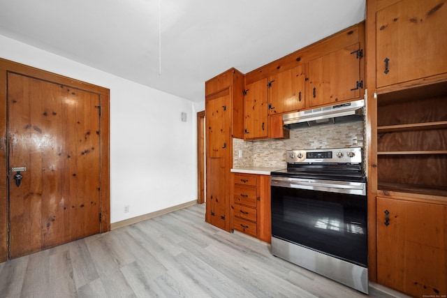 42 Marlboro St, Waterbury, CT 06705 - kitchen with stainless steel range with electric cooktop, under cabinet range hood, tasteful backsplash, light wood-style floors, and brown cabinetry