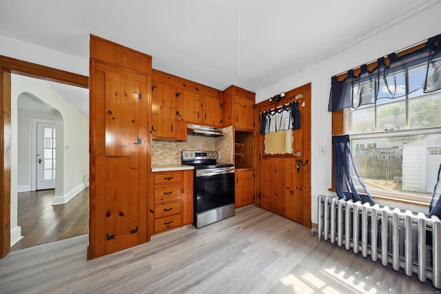 42 Marlboro St, Waterbury, CT 06705 - kitchen with electric range, under cabinet range hood, radiator heating unit, light wood-style floors, and brown cabinets