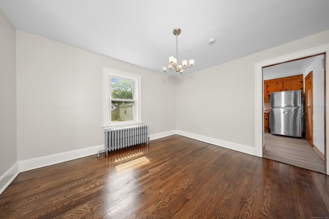 42 Marlboro St, Waterbury, CT 06705 - spare room with radiator, a chandelier, and wood finished floors