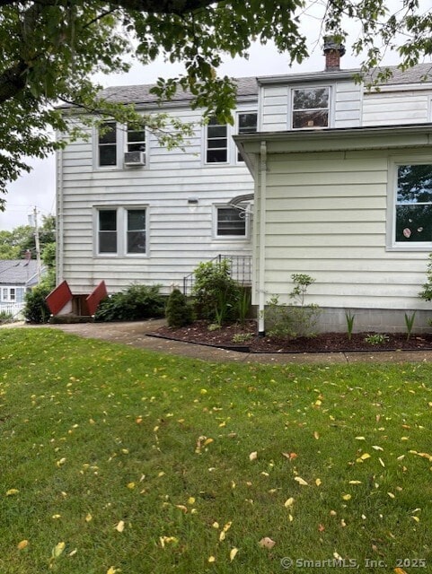 31 Happy St, Norwich, CT 06360 - rear view of property with a lawn and a chimney