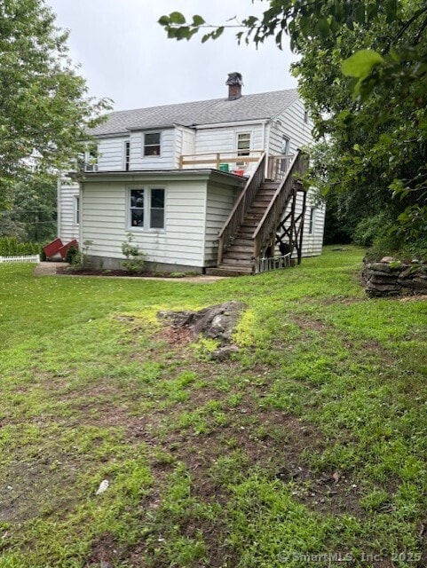31 Happy St, Norwich, CT 06360 - back of house with stairway, a lawn, and a chimney