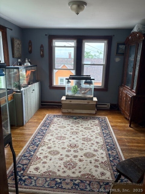 31 Happy St, Norwich, CT 06360 - interior space with healthy amount of natural light, wood finished floors, and baseboard heating