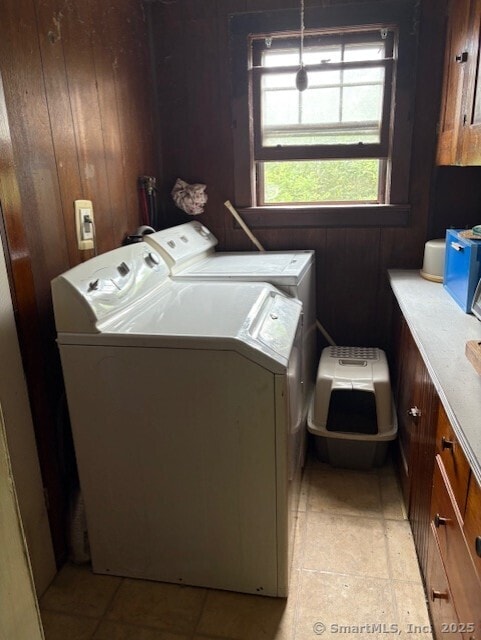 31 Happy St, Norwich, CT 06360 - laundry area featuring separate washer and dryer, cabinet space, and wooden walls