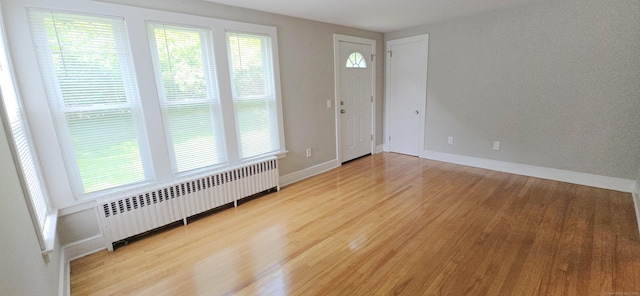 20 Old Stafford Rd, Tolland, CT 06084 - entrance foyer with radiator heating unit, light wood-style flooring, and plenty of natural light