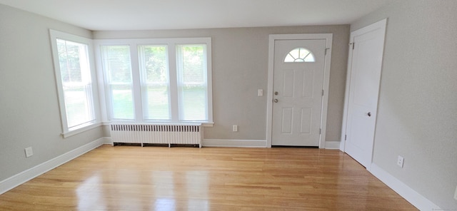 20 Old Stafford Rd, Tolland, CT 06084 - entrance foyer with radiator heating unit, healthy amount of natural light, and light wood-style floors