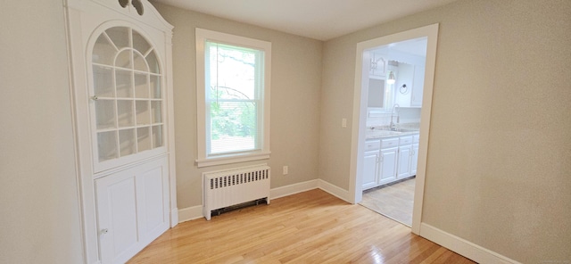 20 Old Stafford Rd, Tolland, CT 06084 - spare room featuring radiator heating unit, light wood finished floors, and plenty of natural light