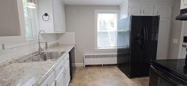 20 Old Stafford Rd, Tolland, CT 06084 - kitchen with radiator, black appliances, plenty of natural light, and white cabinetry