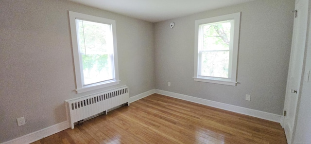 20 Old Stafford Rd, Tolland, CT 06084 - spare room featuring radiator, healthy amount of natural light, and light wood finished floors