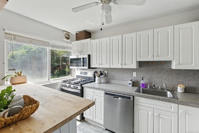 208 Flax Hill Rd Apt 10, Norwalk, CT 06854 - kitchen featuring stainless steel appliances, white cabinetry, a ceiling fan, butcher block counters, and decorative backsplash