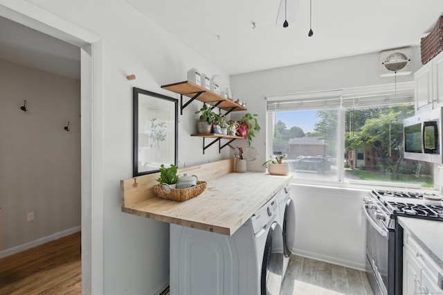 208 Flax Hill Rd Apt 10, Norwalk, CT 06854 - kitchen featuring appliances with stainless steel finishes, light wood-style floors, white cabinets, open shelves, and washing machine and clothes dryer