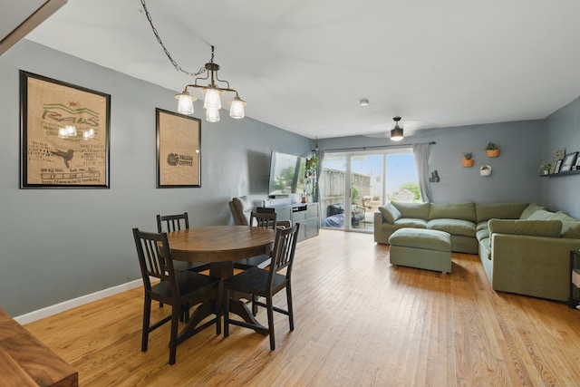 208 Flax Hill Rd Apt 10, Norwalk, CT 06854 - dining area with light wood-type flooring and a chandelier