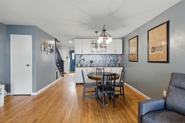 208 Flax Hill Rd Apt 10, Norwalk, CT 06854 - dining space with stairway, light wood-style flooring, a chandelier, and recessed lighting