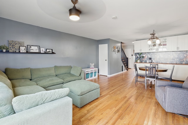 208 Flax Hill Rd Apt 10, Norwalk, CT 06854 - living area featuring stairs, light wood-style floors, a chandelier, and ceiling fan