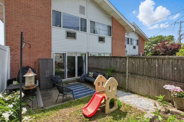208 Flax Hill Rd Apt 10, Norwalk, CT 06854 - back of property with a fenced backyard, a patio, and brick siding