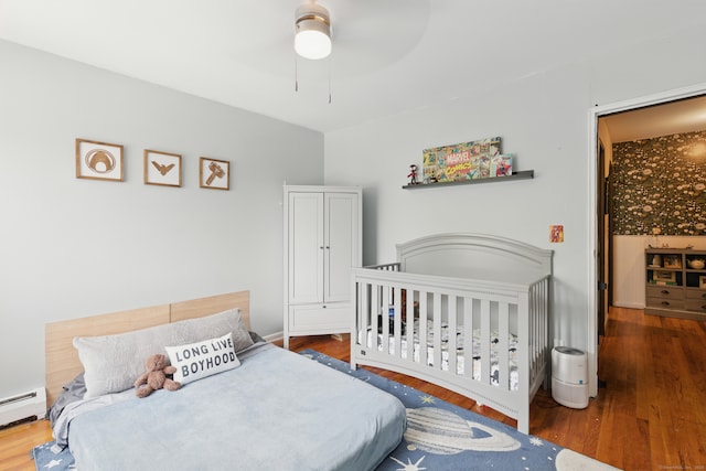 208 Flax Hill Rd Apt 10, Norwalk, CT 06854 - bedroom with wood finished floors, a baseboard heating unit, and ceiling fan