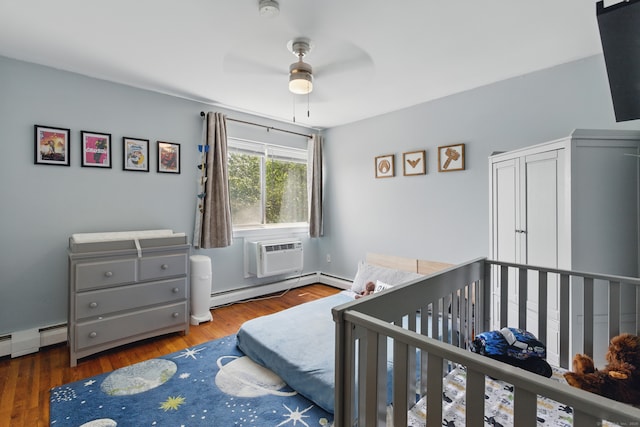 208 Flax Hill Rd Apt 10, Norwalk, CT 06854 - bedroom with baseboard heating, wood finished floors, and an AC wall unit