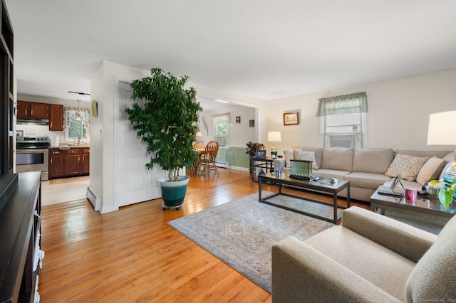 135 Liberty St Unit 135, Clinton, CT 06413 - living room with a baseboard radiator, healthy amount of natural light, light wood-style floors, and cooling unit