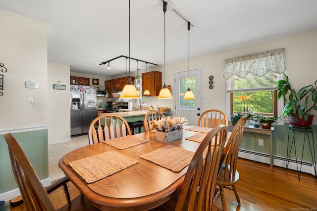 135 Liberty St Unit 135, Clinton, CT 06413 - dining space with rail lighting, a baseboard radiator, and light wood-type flooring