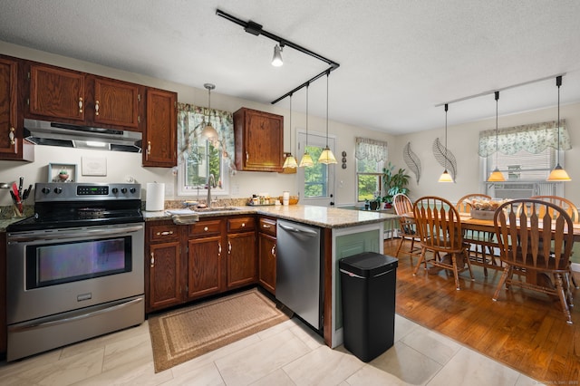 135 Liberty St Unit 135, Clinton, CT 06413 - kitchen featuring stainless steel appliances, under cabinet range hood, rail lighting, a peninsula, and a textured ceiling