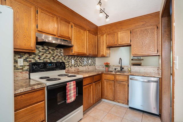 80 Copper Beech Dr Unit 80, Rocky Hill, CT 06067 - kitchen with white appliances, under cabinet range hood, light tile patterned floors, and brown cabinetry