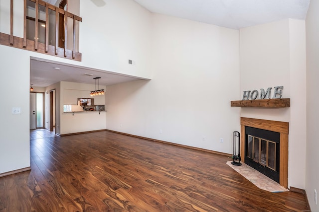 80 Copper Beech Dr Unit 80, Rocky Hill, CT 06067 - unfurnished living room featuring dark wood finished floors, a fireplace with flush hearth, and a high ceiling