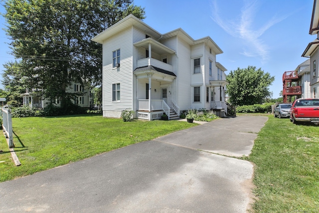 93 S St, Bristol, CT 06010 - view of front of house featuring a balcony, a front yard, and driveway