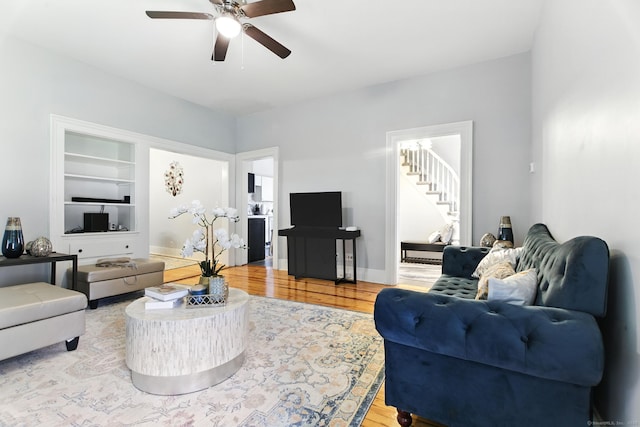 93 S St, Bristol, CT 06010 - living area featuring a ceiling fan, wood finished floors, stairway, and built in shelves