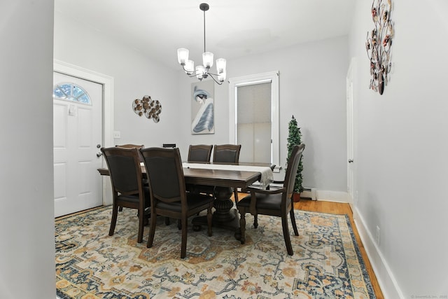 93 S St, Bristol, CT 06010 - dining area with a chandelier, wood finished floors, and baseboard heating