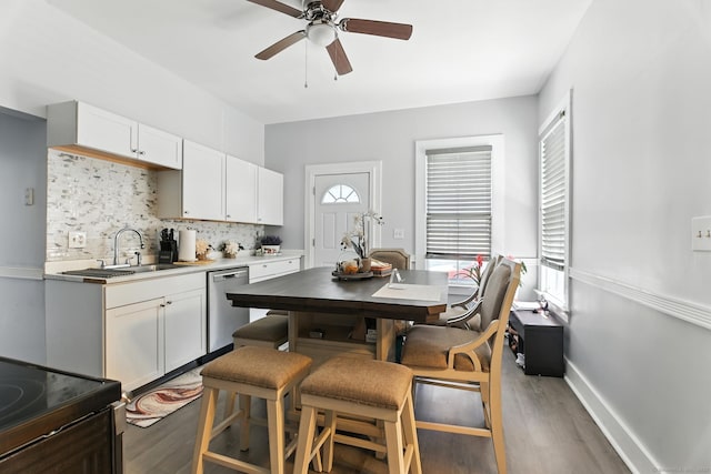 93 S St, Bristol, CT 06010 - kitchen featuring appliances with stainless steel finishes, light wood-type flooring, backsplash, ceiling fan, and white cabinetry