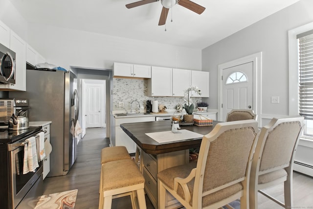 93 S St, Bristol, CT 06010 - kitchen featuring stainless steel appliances, ceiling fan, light countertops, wood finished floors, and white cabinets