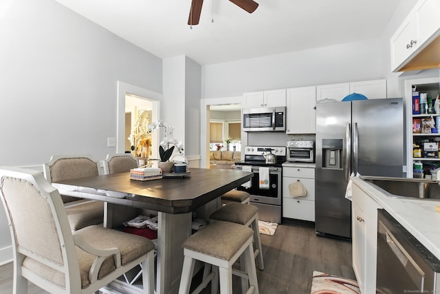 93 S St, Bristol, CT 06010 - kitchen featuring appliances with stainless steel finishes, ceiling fan, white cabinets, dark wood-type flooring, and light countertops