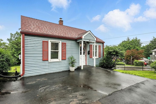 85 Peck St, Berlin, CT 06037 - view of front of property with roof with shingles and a chimney