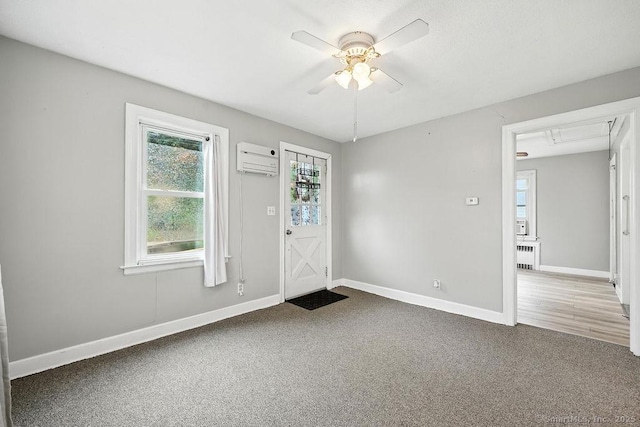 85 Peck St, Berlin, CT 06037 - foyer entrance featuring radiator, a wall mounted AC, healthy amount of natural light, and carpet floors