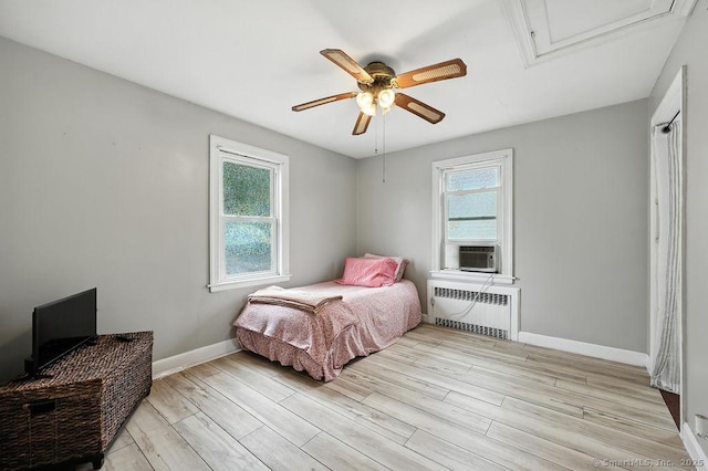 85 Peck St, Berlin, CT 06037 - bedroom featuring radiator heating unit, multiple windows, light wood finished floors, and attic access