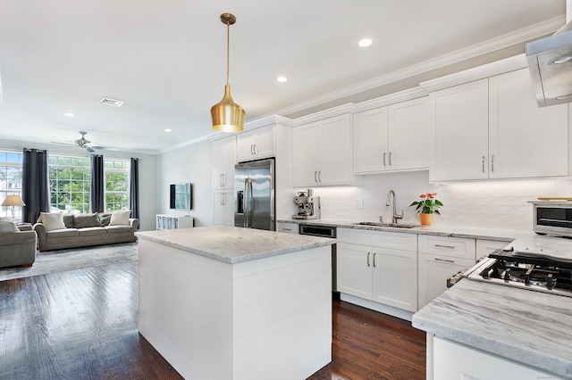 157 Brentwood Ave Unit 157, Fairfield, CT 06825 - kitchen with stainless steel fridge, ornamental molding, a ceiling fan, a center island, and white cabinetry