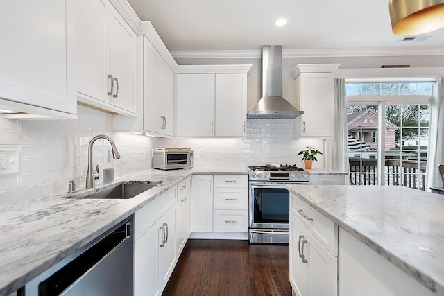 157 Brentwood Ave Unit 157, Fairfield, CT 06825 - kitchen with wall chimney exhaust hood, stainless steel appliances, ornamental molding, white cabinetry, and dark wood-type flooring