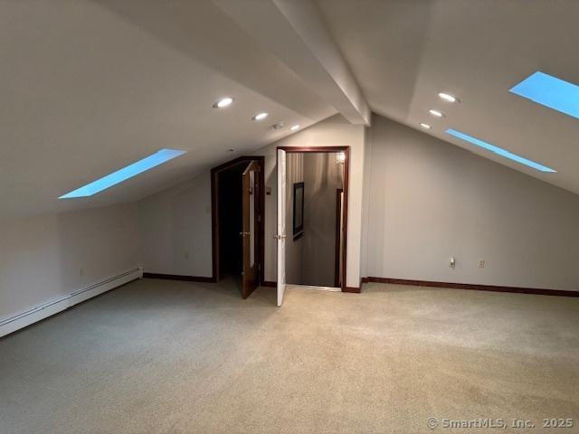 56 Cedar Swamp Rd, Mansfield, CT 06268 - additional living space featuring a skylight, vaulted ceiling, light carpet, recessed lighting, and a baseboard radiator
