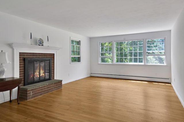 3 Deerfield Dr, Clinton, CT 06413 - unfurnished living room featuring a baseboard heating unit, wood finished floors, and a brick fireplace