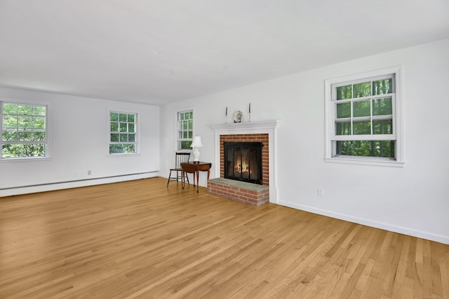 3 Deerfield Dr, Clinton, CT 06413 - unfurnished living room featuring light wood finished floors, a fireplace, and a baseboard heating unit