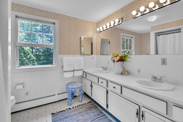 3 Deerfield Dr, Clinton, CT 06413 - bathroom featuring a baseboard heating unit, tile walls, double vanity, crown molding, and wallpapered walls