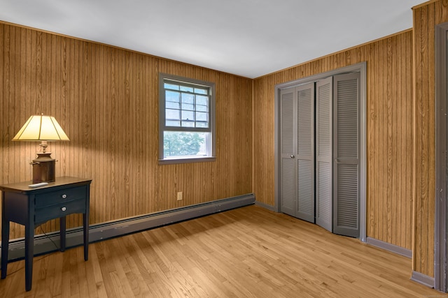 3 Deerfield Dr, Clinton, CT 06413 - unfurnished bedroom with baseboard heating, a closet, and light wood-style floors