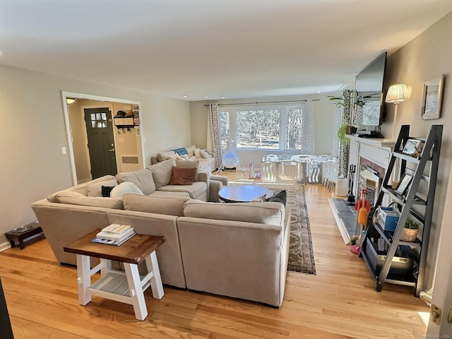 4380 Whitney Ave, Hamden, CT 06518 - living area featuring light wood-type flooring and a fireplace